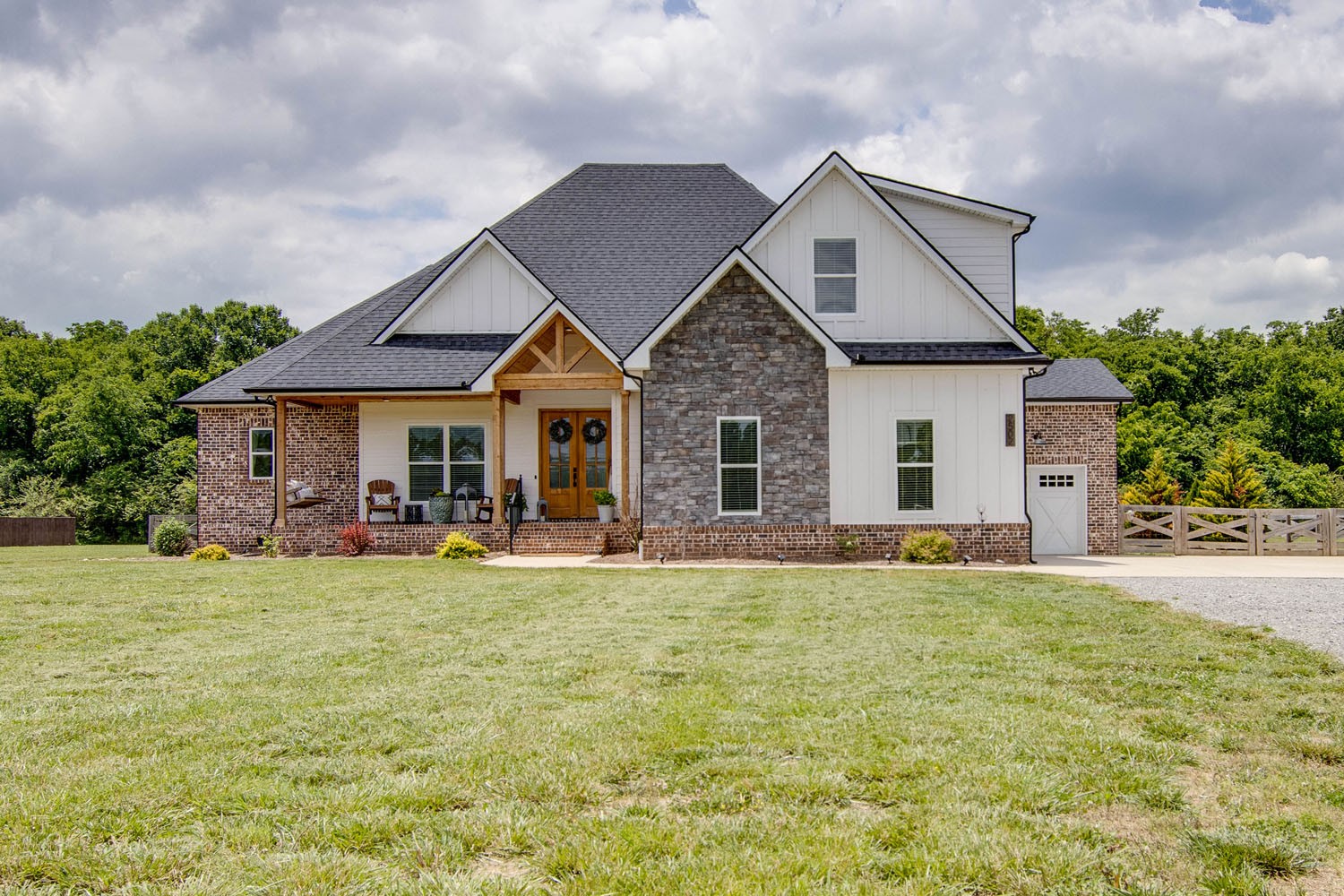 a front view of a house with that has plants and garden