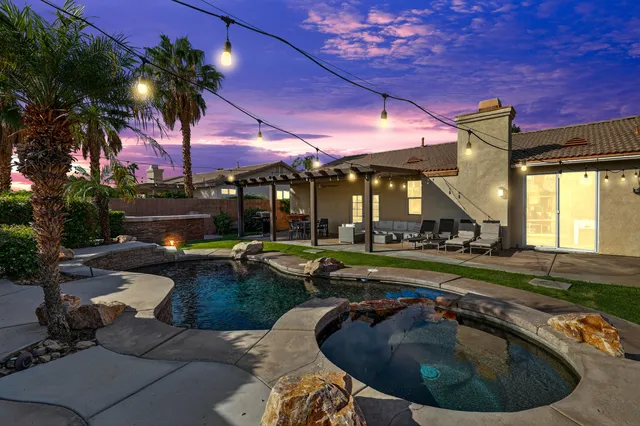 a view of a house with swimming pool and sitting area