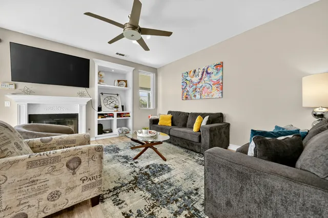 a living room with furniture fireplace and flat screen tv