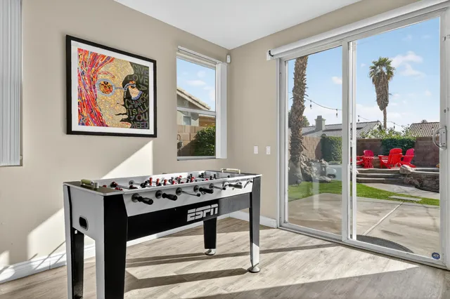a view of a dining room with a table and chairs