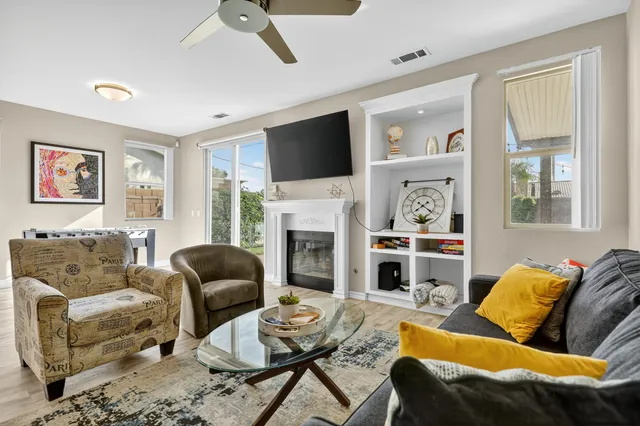 a living room with furniture fireplace and a flat screen tv