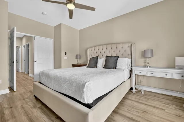 a large bed sitting in a bedroom and a chandelier