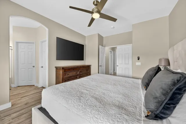 a bedroom with a bed and a flat screen tv