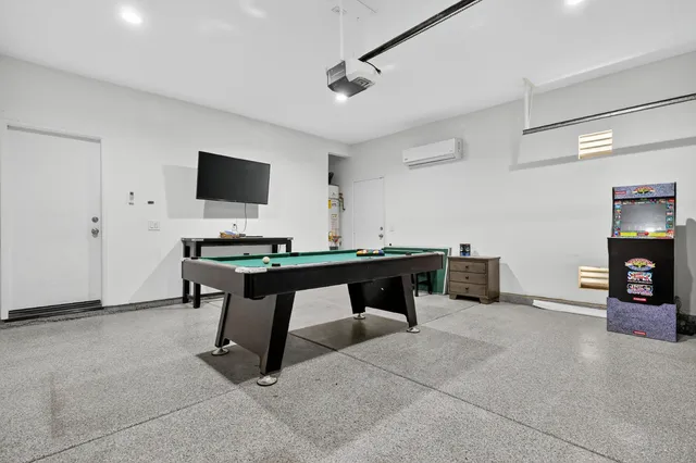 a view of a workspace with a projector and furniture