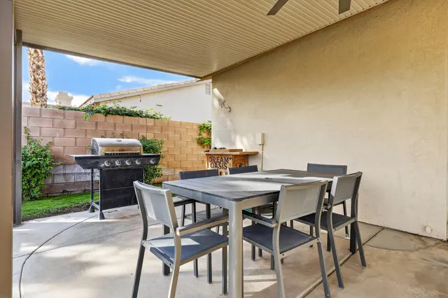 a view of a backyard with table and chairs