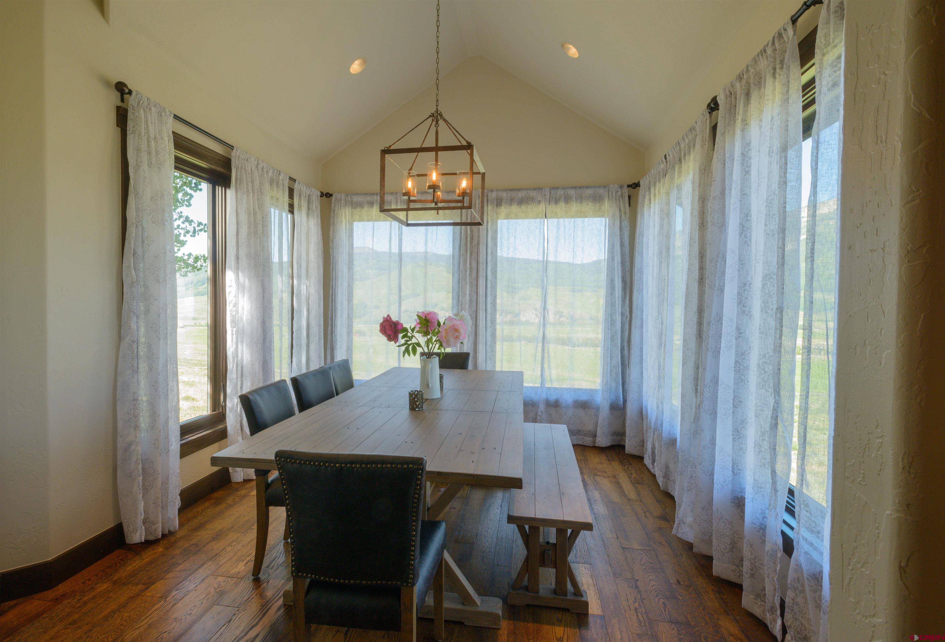 660 Lower Highlands Road Crested Butte, CO 81224 - Photo 13 of 31 a view of a dining room with furniture window and wooden floor