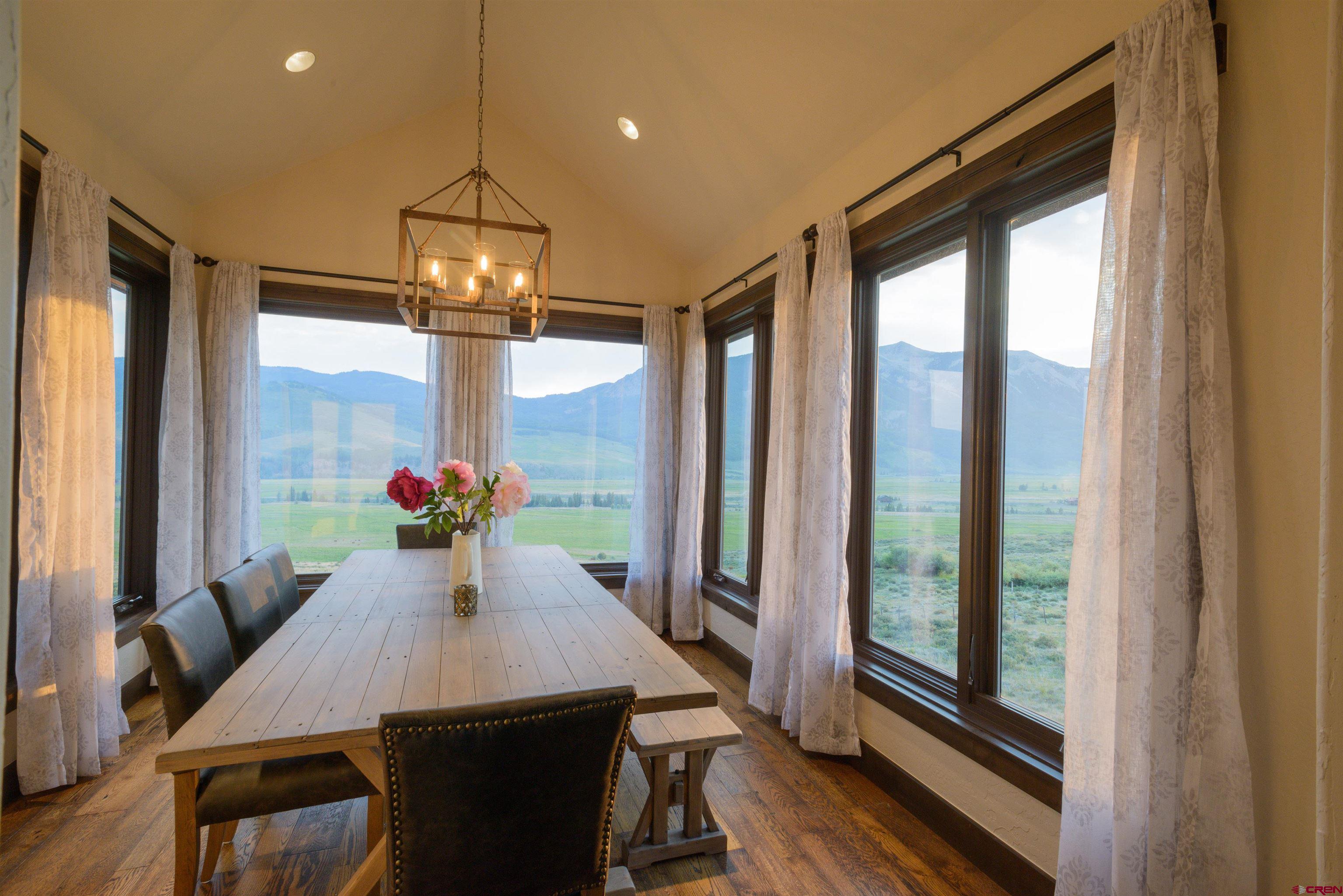 660 Lower Highlands Road Crested Butte, CO 81224 - Photo 14 of 31 a view of a dining room with furniture window and wooden floor