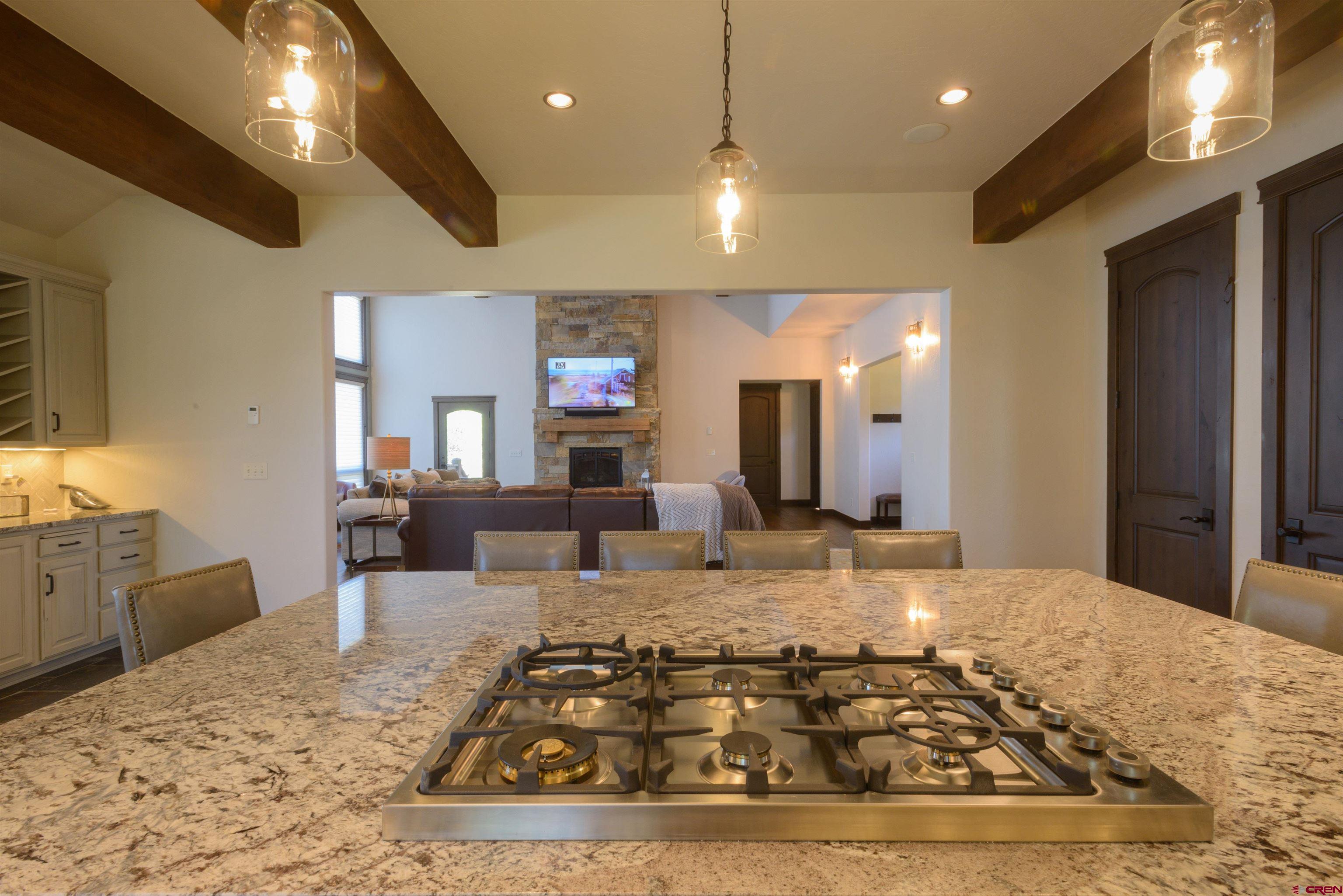 660 Lower Highlands Road Crested Butte, CO 81224 - Photo 16 of 31 a large hall with stainless steel appliances granite countertop a stove and white cabinets