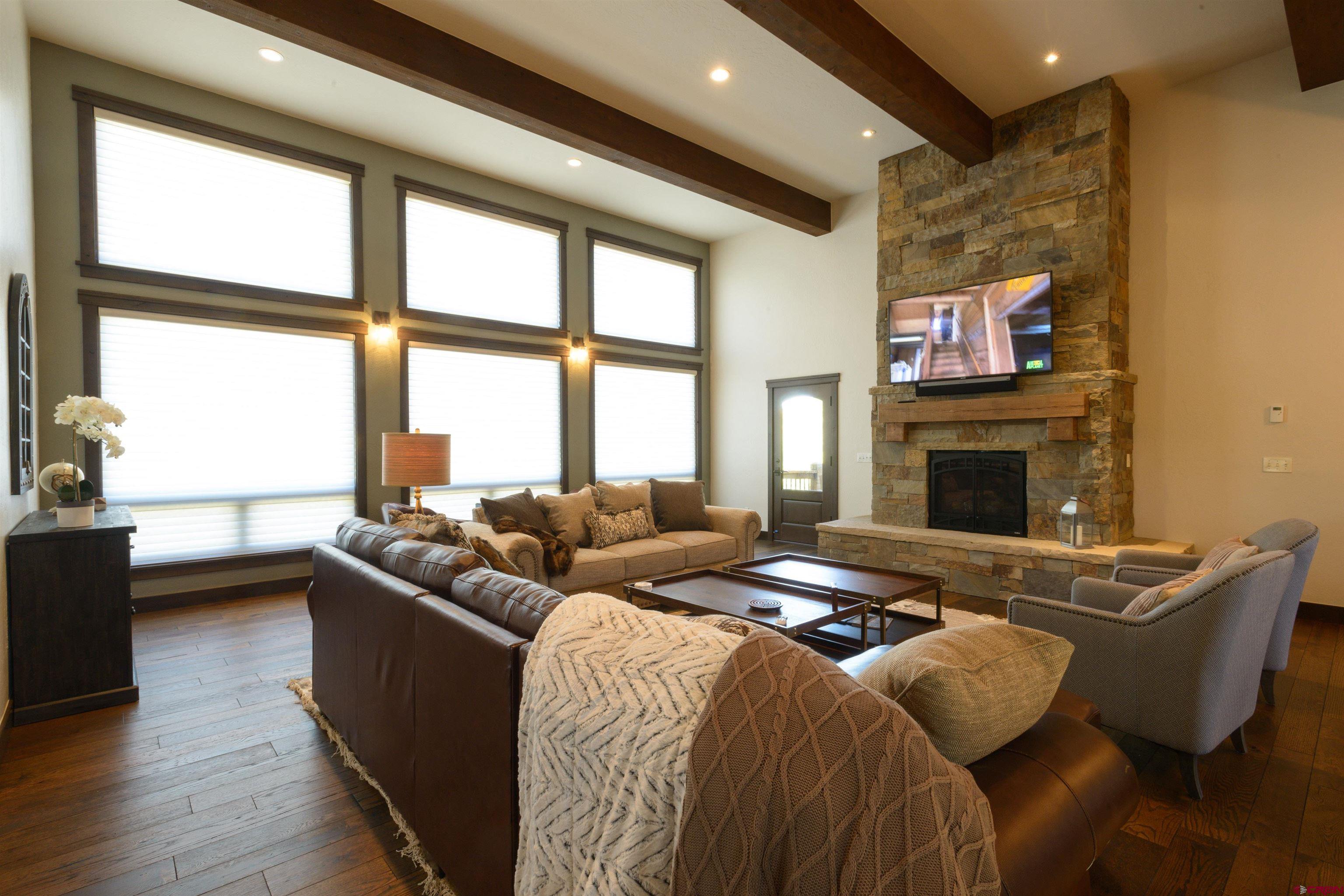 660 Lower Highlands Road Crested Butte, CO 81224 - Photo 17 of 31 a bedroom with furniture and a fireplace