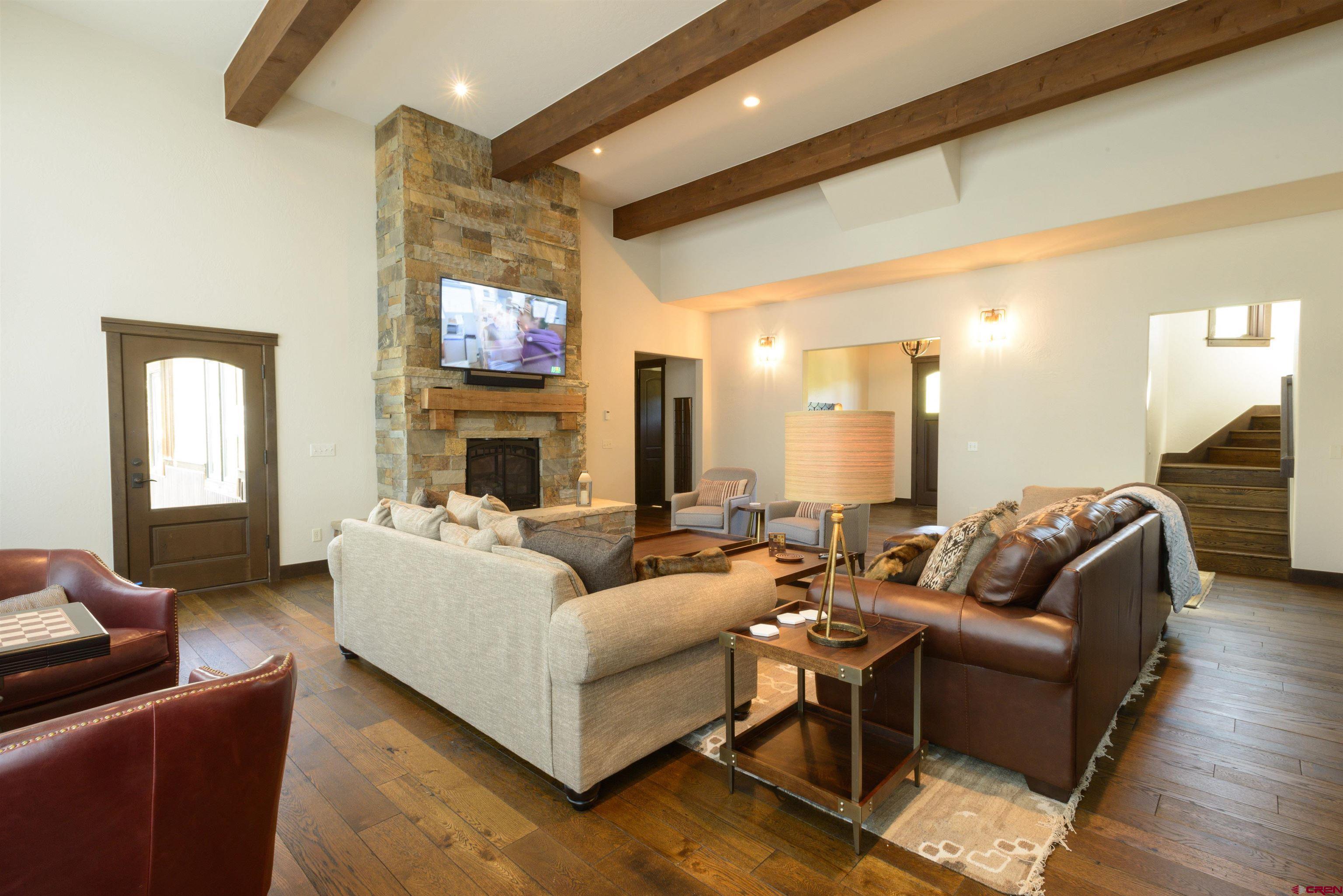 660 Lower Highlands Road Crested Butte, CO 81224 - Photo 18 of 31 a living room with fireplace furniture and a flat screen tv