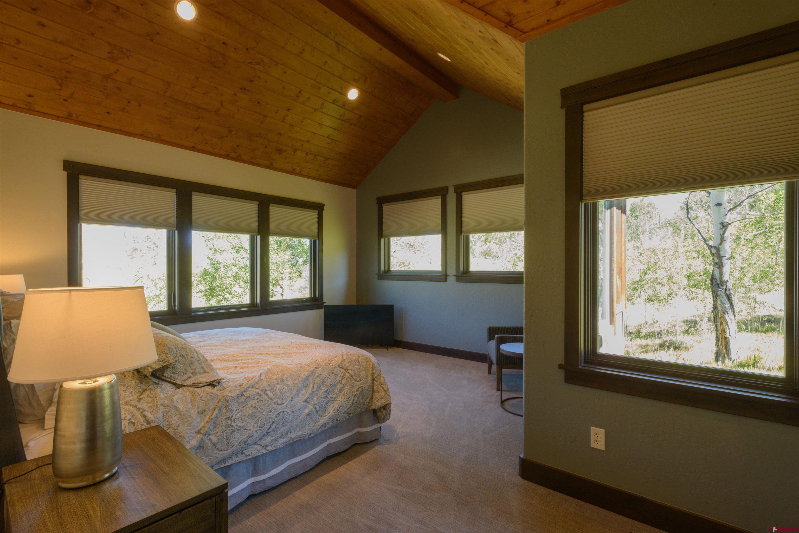 660 Lower Highlands Road Crested Butte, CO 81224 - Photo 19 of 31 a bedroom with a bed and wooden floor