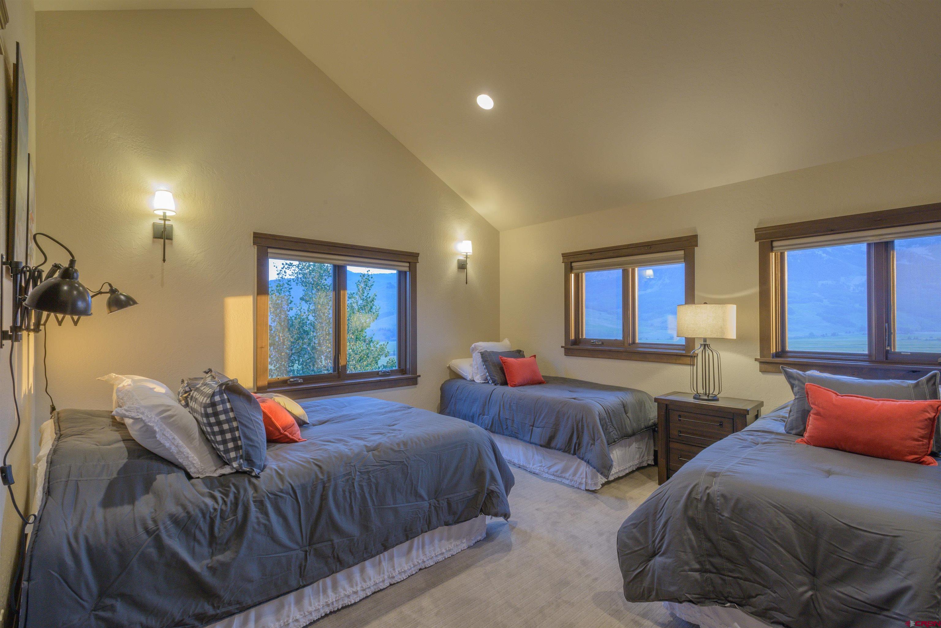 660 Lower Highlands Road Crested Butte, CO 81224 - Photo 25 of 31 a bedroom with two beds and a large window