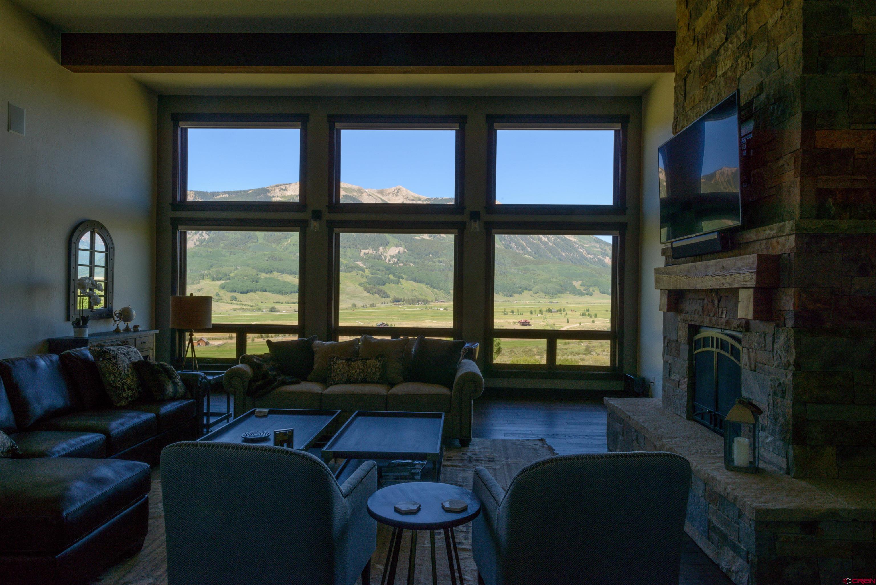 660 Lower Highlands Road Crested Butte, CO 81224 - Photo 27 of 31 a living room with furniture tv and a fireplace