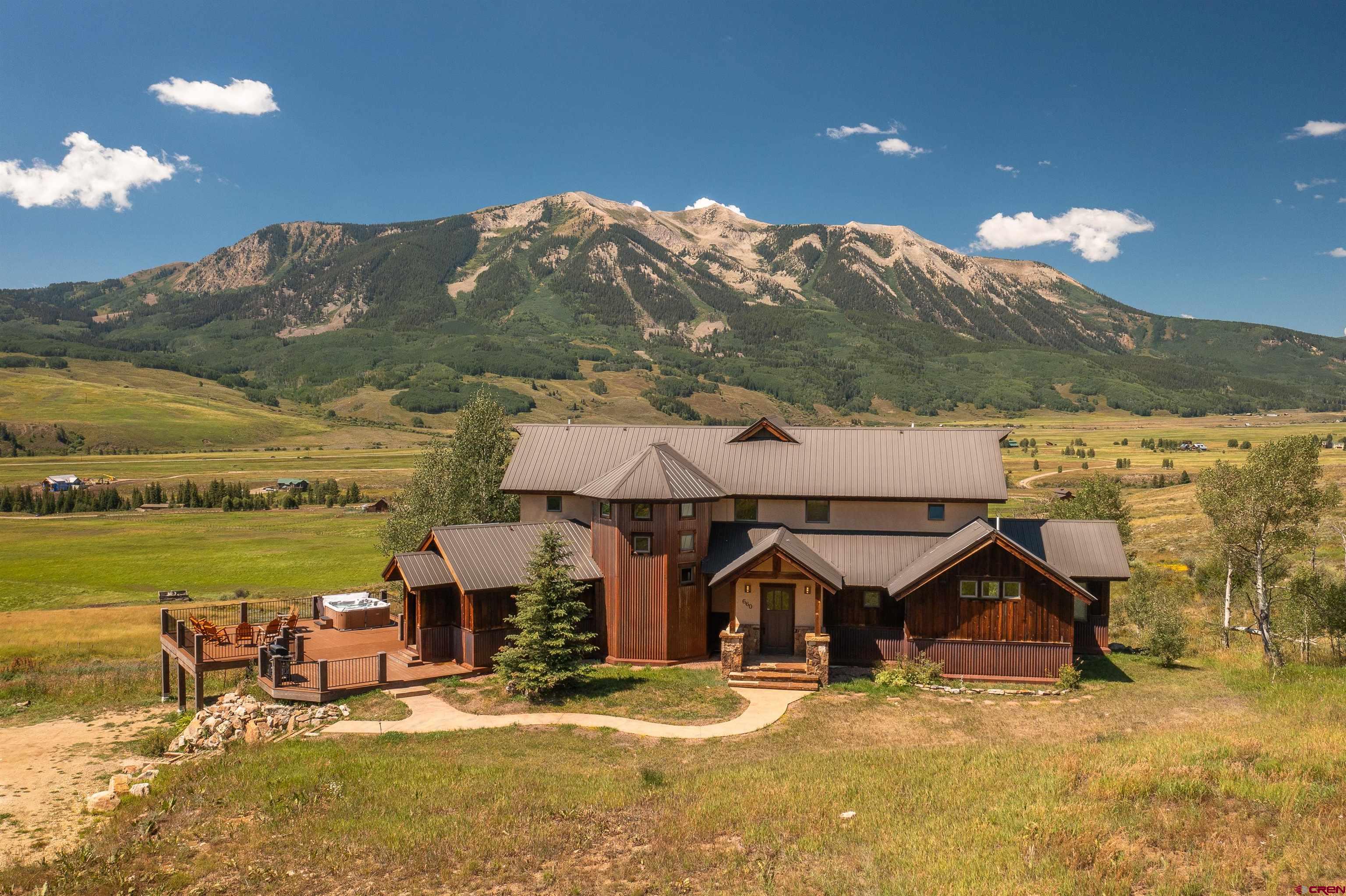 660 Lower Highlands Road Crested Butte, CO 81224 - Photo 29 of 31 a view of a house with yard and ocean view