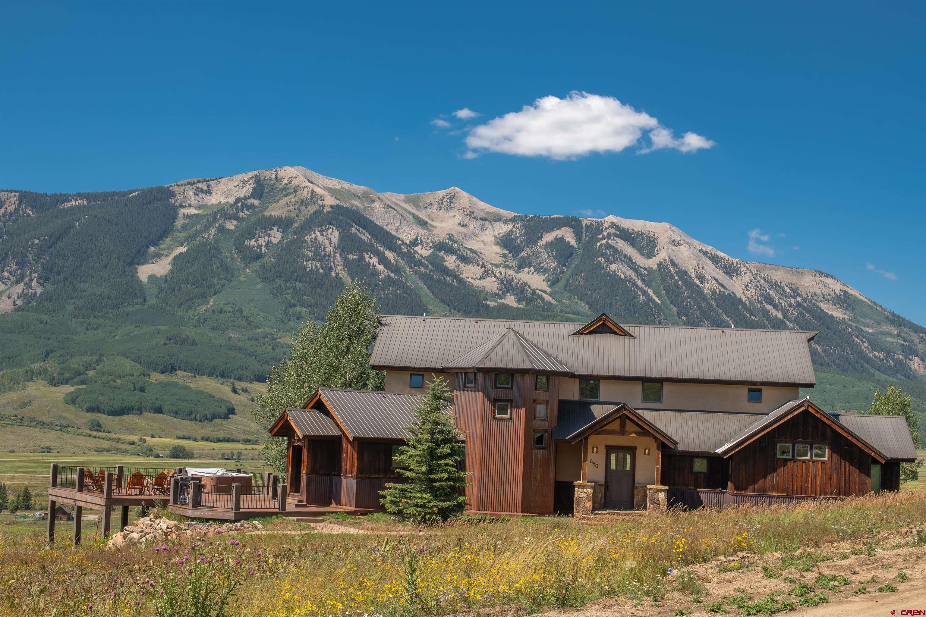 660 Lower Highlands Road Crested Butte, CO 81224 - Photo 5 of 31 a front view of a house with a yard