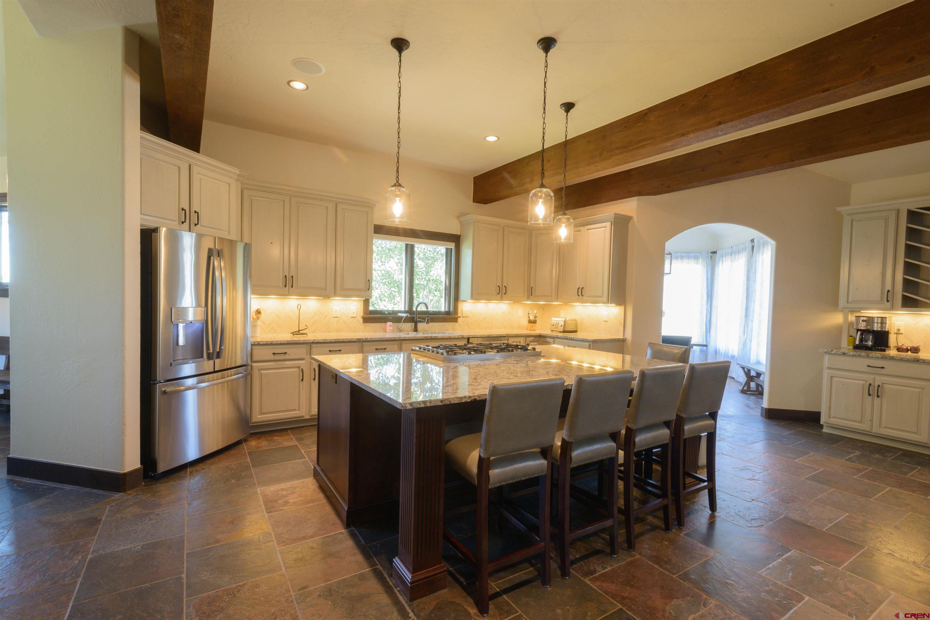 660 Lower Highlands Road Crested Butte, CO 81224 - Photo 9 of 31 a kitchen with stainless steel appliances granite countertop a refrigerator a sink a stove and a refrigerator