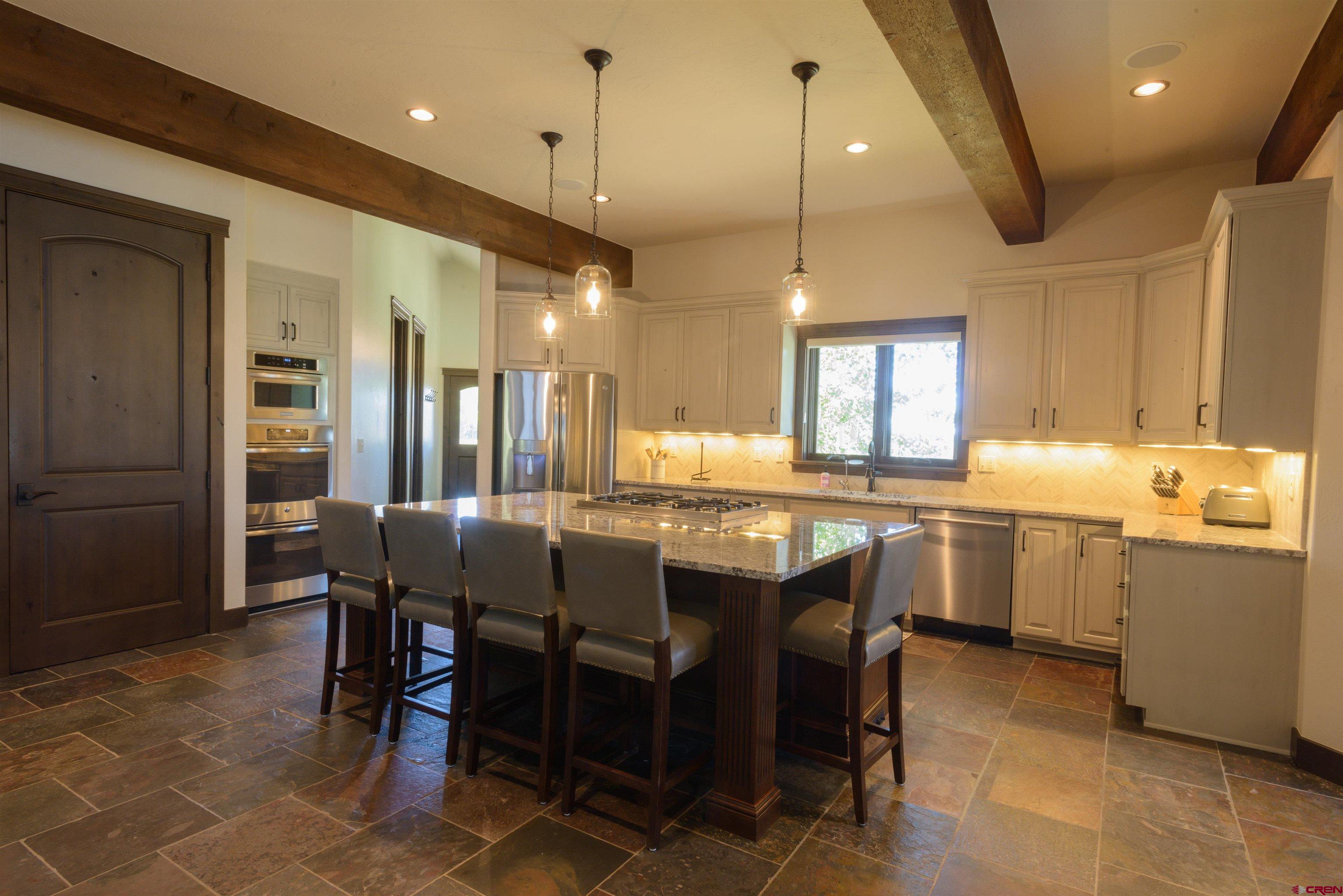 660 Lower Highlands Road Crested Butte, CO 81224 - Photo 10 of 31 a large kitchen with a table and chairs
