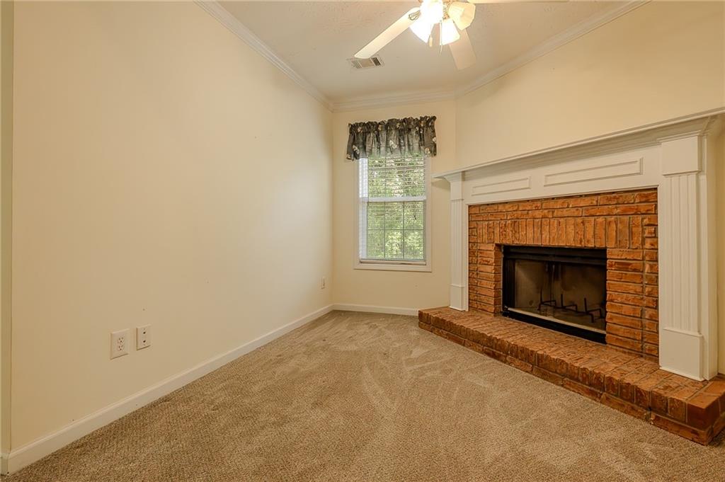 160 Vinny's Way Covington, GA 30014 - Photo 11 of 51 an empty room with a fireplace and window