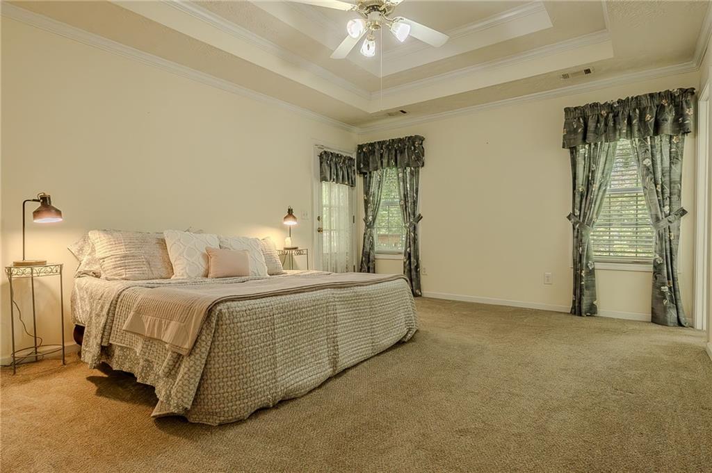 160 Vinny's Way Covington, GA 30014 - Photo 12 of 51 a spacious bedroom with a bed and a chandelier