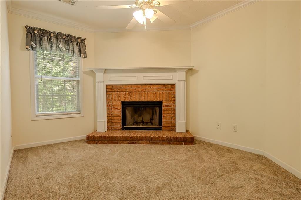 160 Vinny's Way Covington, GA 30014 - Photo 13 of 51 an empty room with windows and fireplace