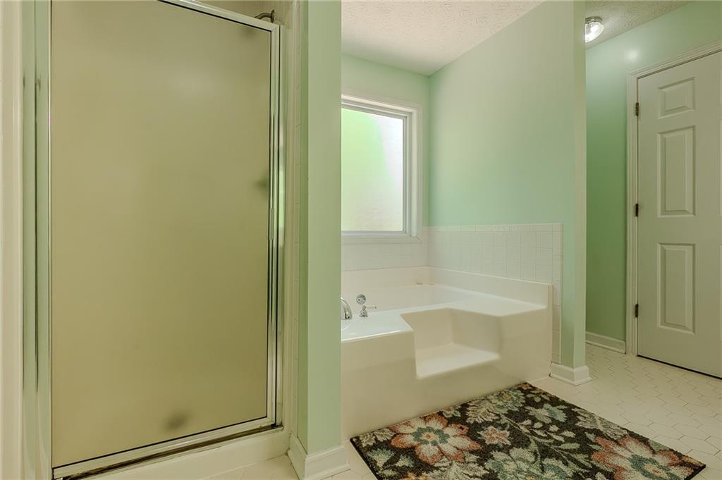 160 Vinny's Way Covington, GA 30014 - Photo 16 of 51 a bathroom with a bathtub and shower