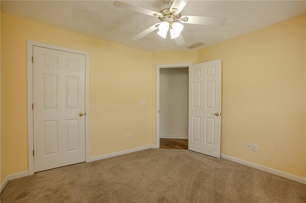 160 Vinny's Way Covington, GA 30014 - Photo 21 of 51 an empty room with a ceiling fan and a window