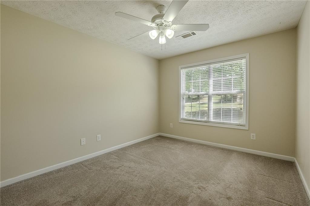 160 Vinny's Way Covington, GA 30014 - Photo 22 of 51 an empty room with a window and a fan