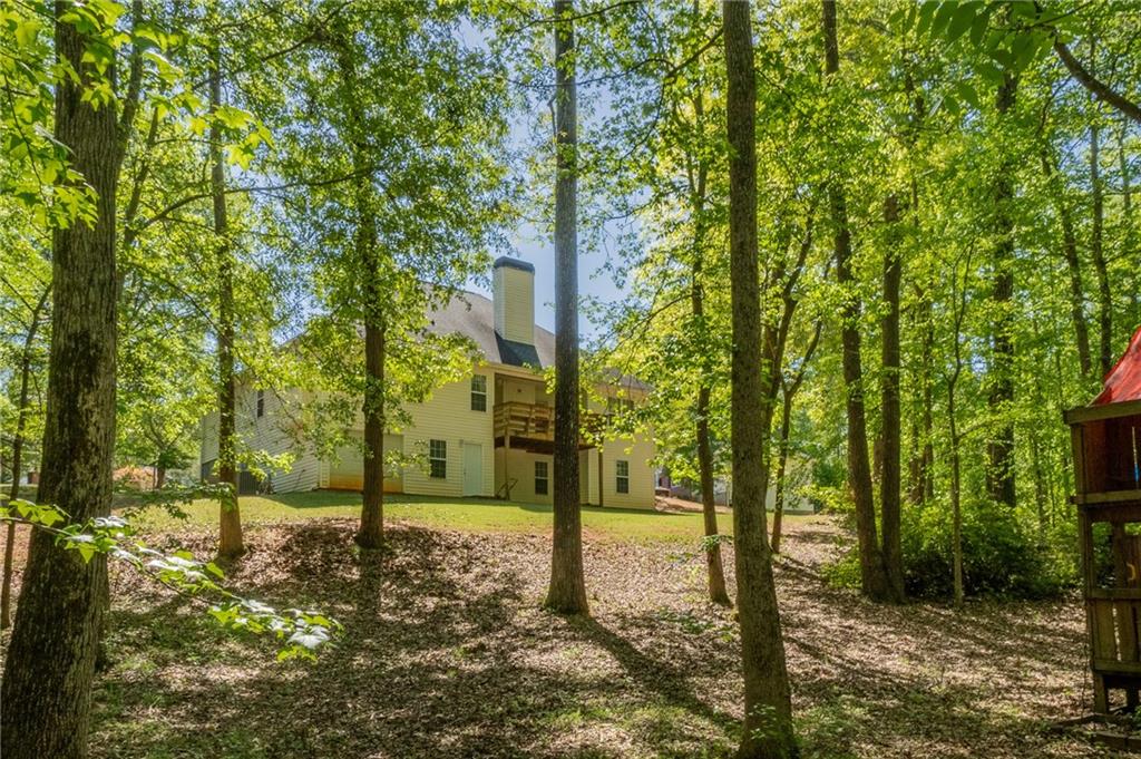 160 Vinny's Way Covington, GA 30014 - Photo 47 of 51 a backyard of a house with lots of trees