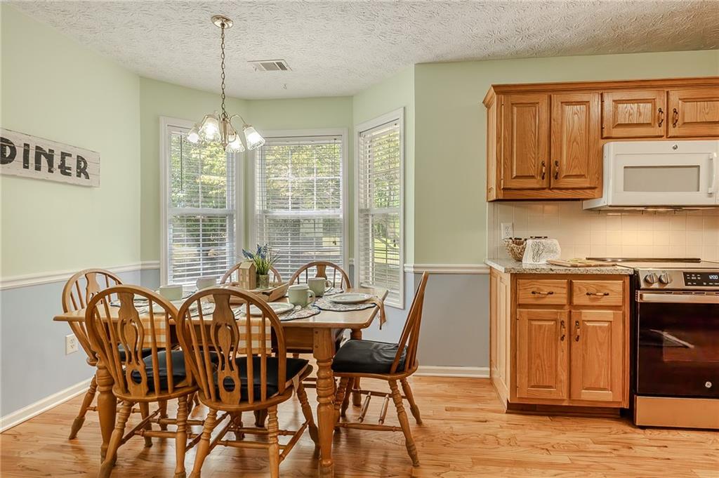 160 Vinny's Way Covington, GA 30014 - Photo 6 of 51 a view of a dining room with furniture window and wooden floor