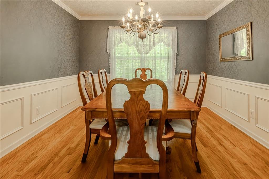160 Vinny's Way Covington, GA 30014 - Photo 9 of 51 a view of a dining room with furniture a chandelier and wooden floor