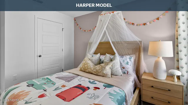 a bedroom with a bed and a wall painting