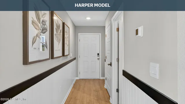 a view of a hallway with wooden floor and entryway