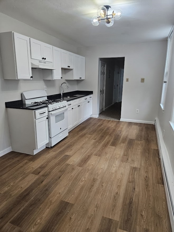 33 Rockland Street, Unit 2 Canton, MA 02021 - Photo 3 of 10 a kitchen with granite countertop a stove a sink and a refrigerator