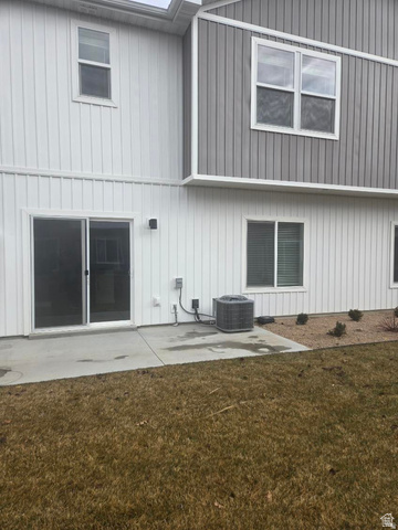 929 North 960 West Tremonton, UT 84337 - Photo 3 of 20 Rear exterior featuring a concrete patio, sliding glass door, and white vertical siding