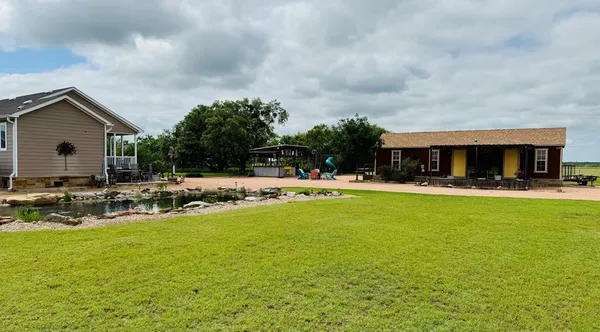 a view of house with swimming pool and outdoor seating