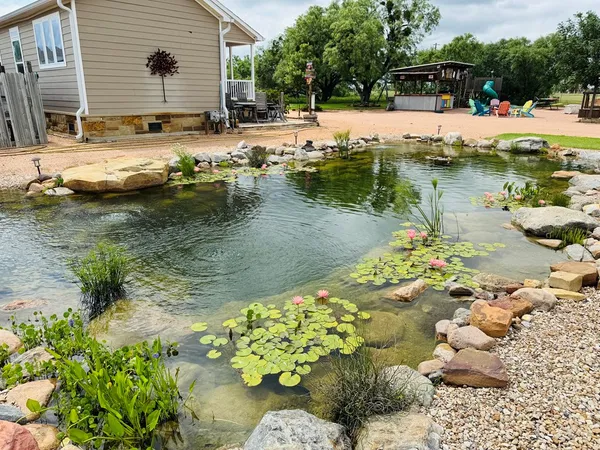 a view of swimming pool with a yard and sitting area