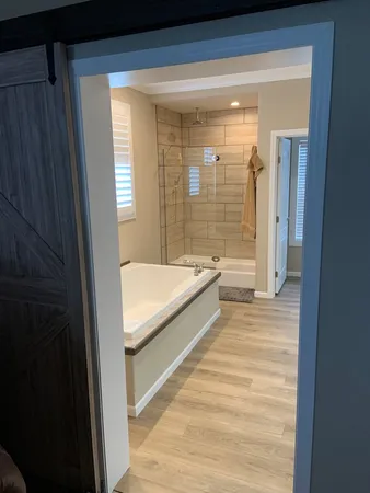 a bathroom with a bathtub and a shower