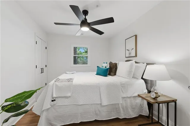 a bedroom with a bed and a large window