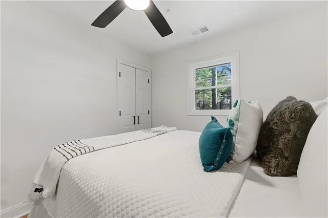 a bathroom with a toilet sink a mirror a vanity and shower