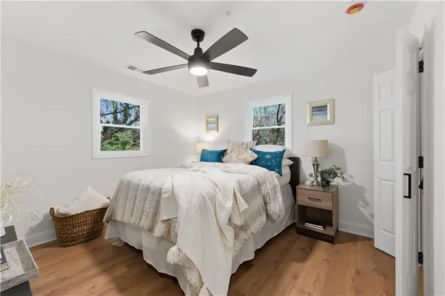 a spacious bedroom with a bed and a chandelier