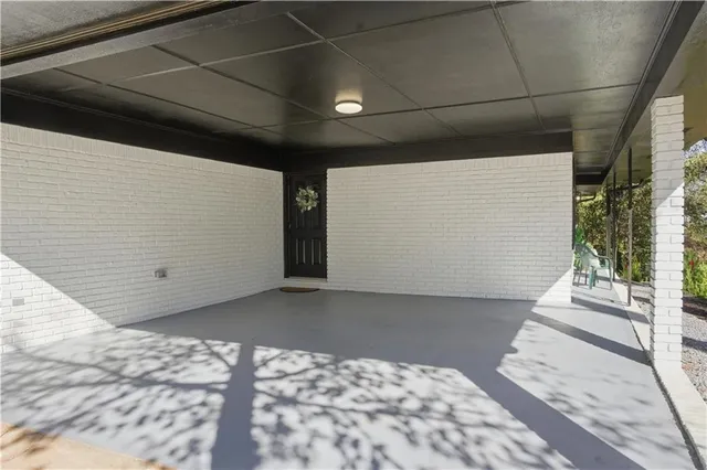 a front view of a house with basket ball court and outdoor seating