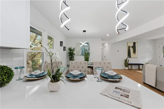 a living room with furniture or chandelier and a wooden floor