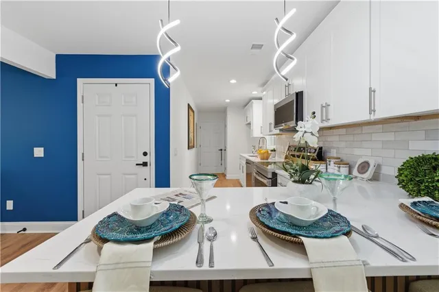 a kitchen with cabinets and wooden floor