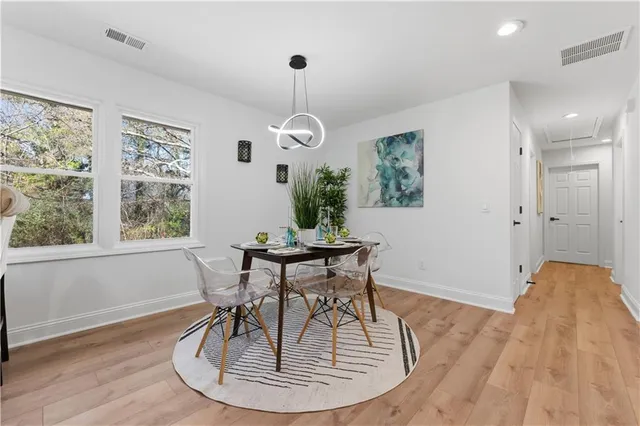 a living room with furniture fireplace and a large window