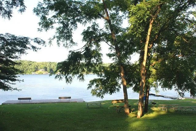 a swimming pool with barbeque oven and outdoor seating