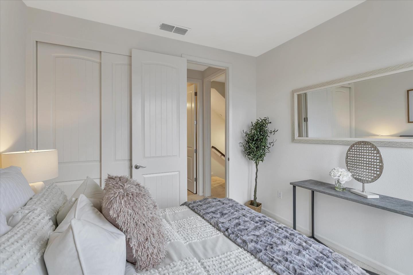 5814 Riley Way Newark, CA 94560 - Photo 18 of 46 a bedroom with a bed and chandelier