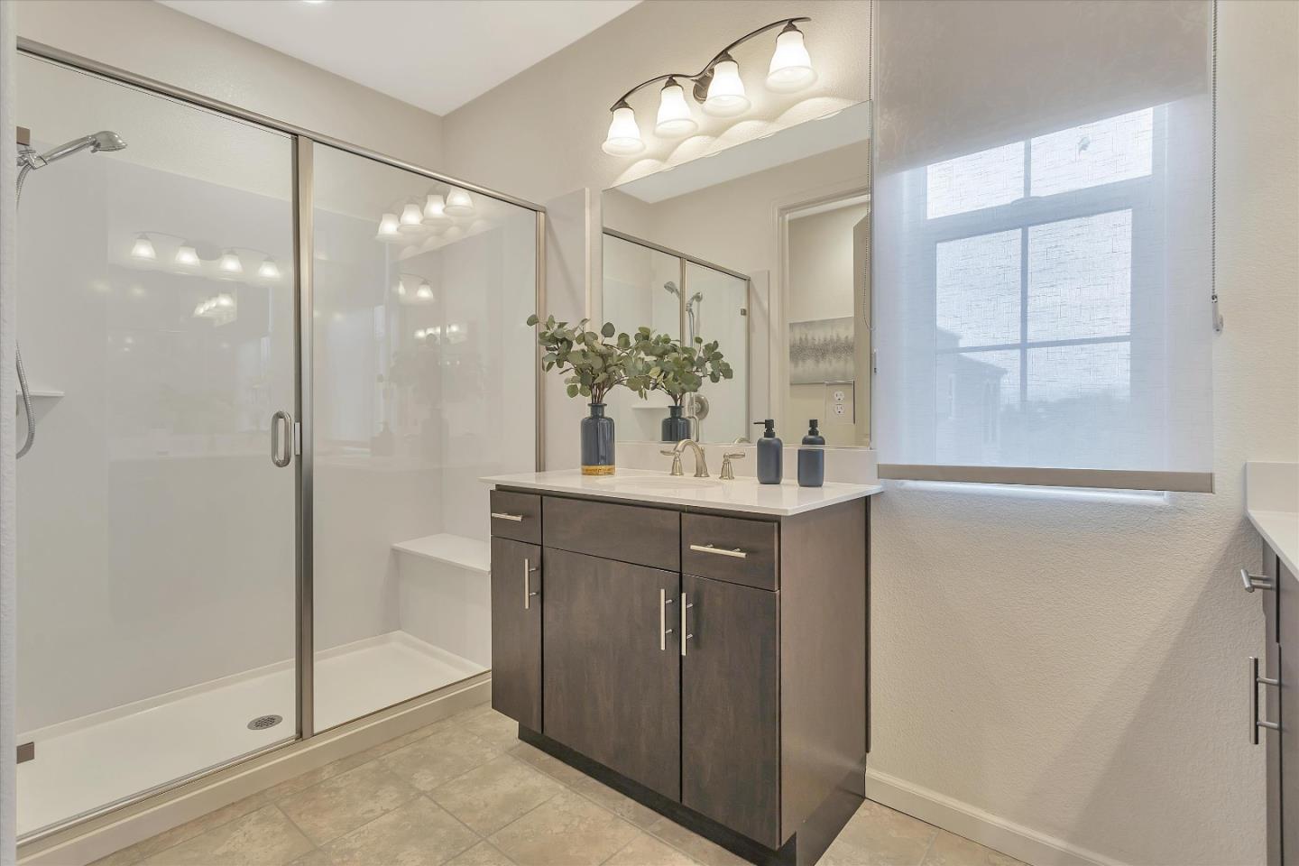 5814 Riley Way Newark, CA 94560 - Photo 28 of 46 a bathroom with a shower sink and mirror