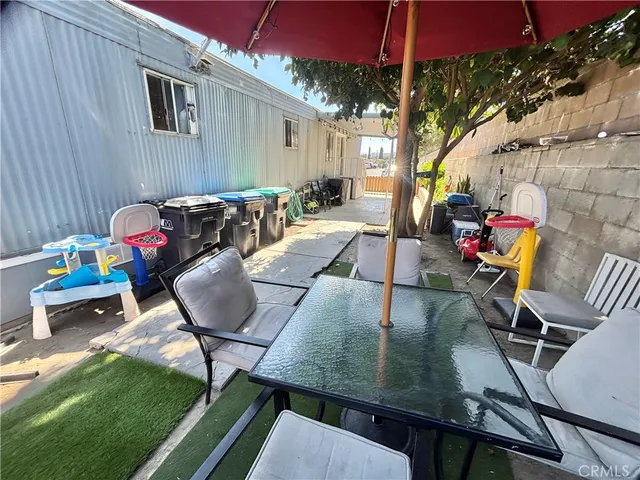 a view of a patio with table and chairs potted plants with wooden floor