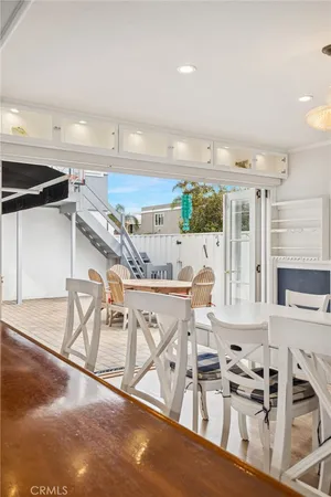 a view of a kitchen with kitchen island stainless steel appliances wooden floor and seating