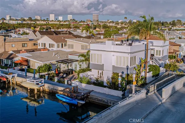 an aerial view of multiple houses with a yard